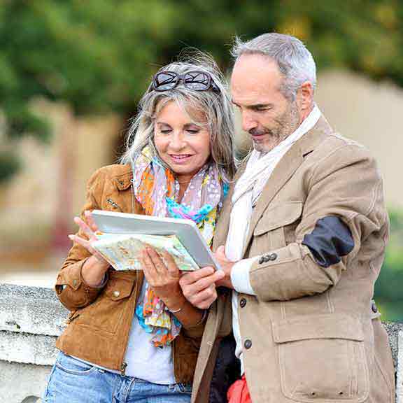 couple checking directions while travelling square