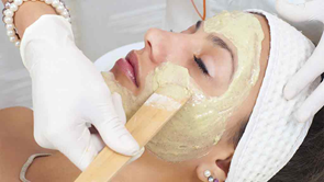 woman having cosmetic mask applied