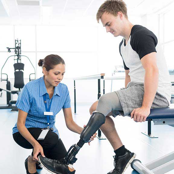 physio with patient prosthetic limb landing sq