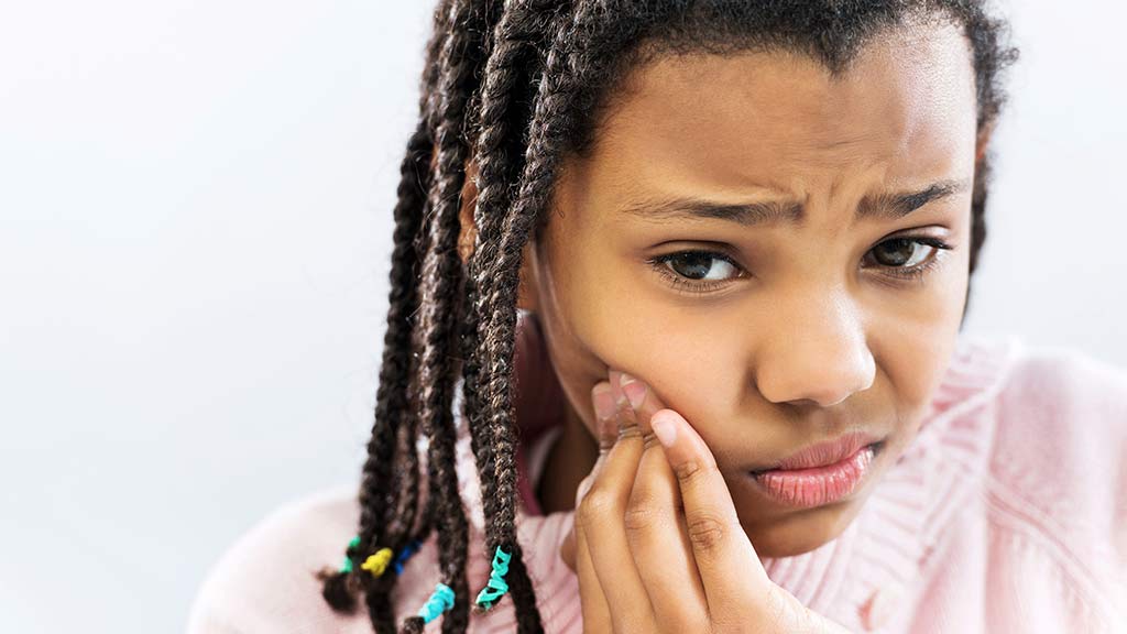 young girl with dental pain