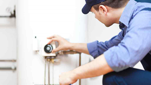 work man checking a hot water system