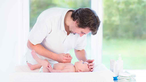 dad with baby on changing table