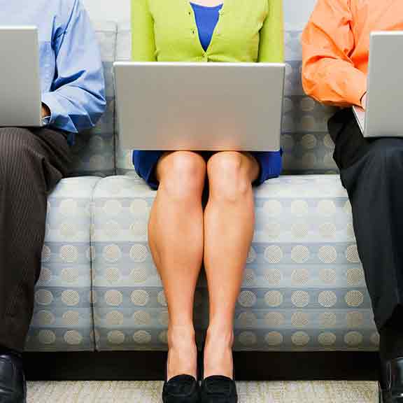 three people sitting with laptops sq