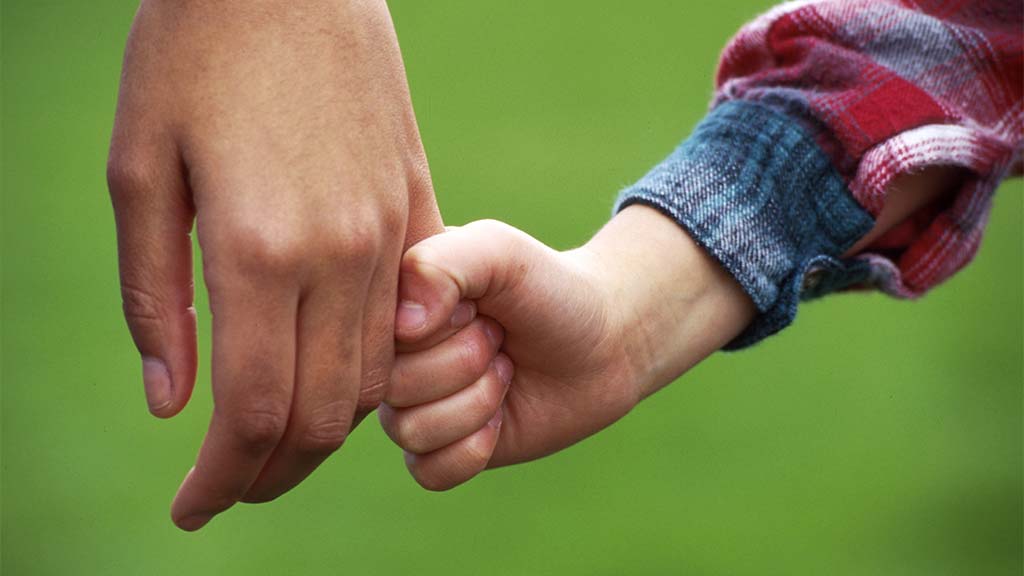 parents holds childs hand
