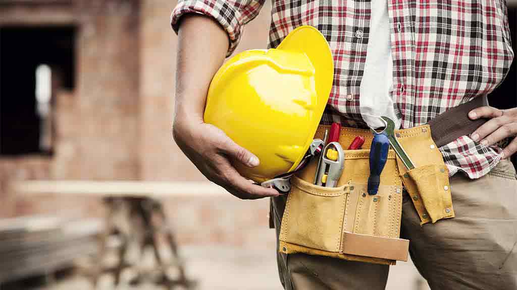 builder holds hard hat