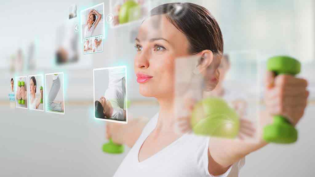 woman lifts weight in front of screen