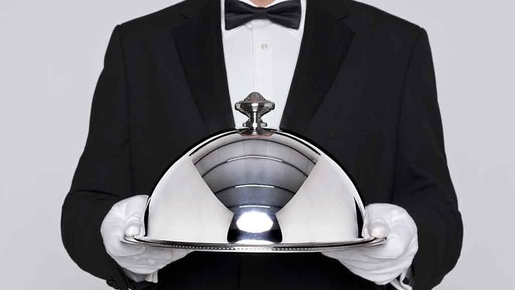 butler holds silver tray