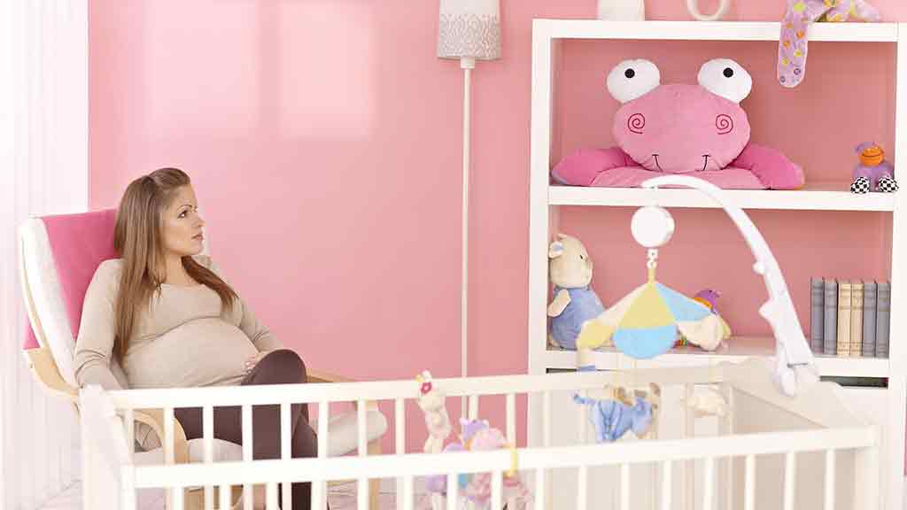 pregnant woman in baby room