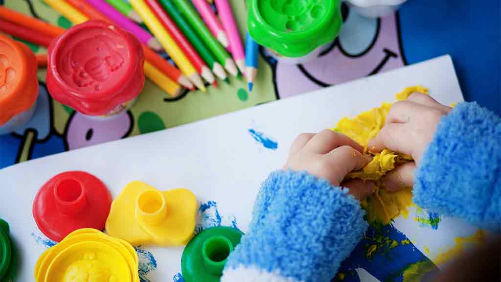 child playing with playdough