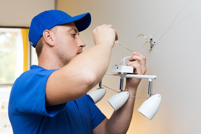 electrician fixing light at home