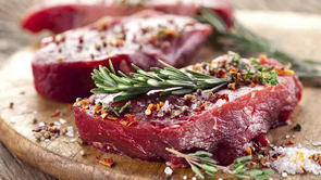 raw meat with herbs on baord