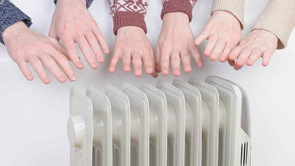hands held over column heater