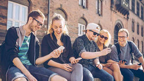 group of young people on mobile phones