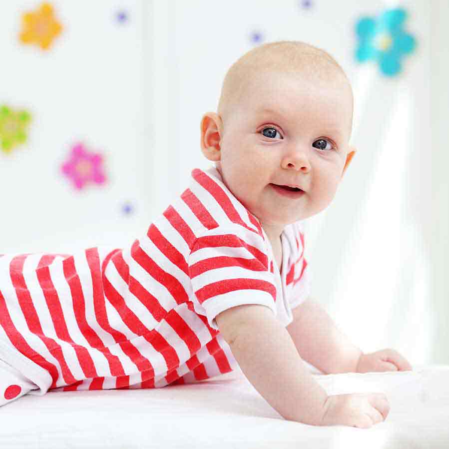 baby wears red stripey jumpsuit square