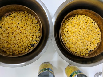 canned corn kernels draining in sieve