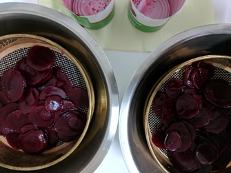 canned beetroot draining in sieve