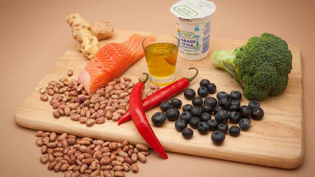 superfoods salmon blueberries chilli broccoli on a board