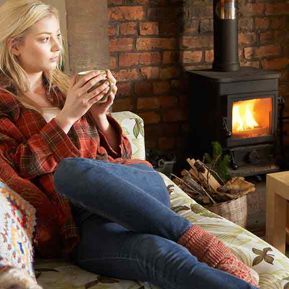 woman heating home with a fire square