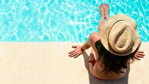woman sits by pool