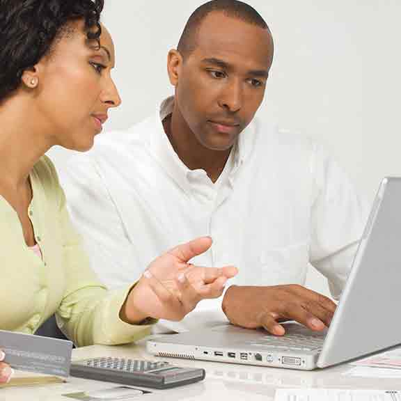 couple looking at laptop and calculator square