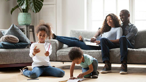 family sitting on sofa lounge