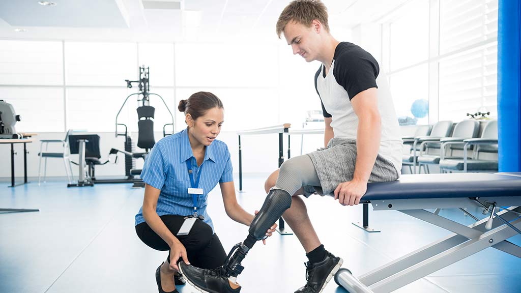 physio with patient prosthetic limb landing