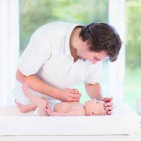 dad with baby on changing table square