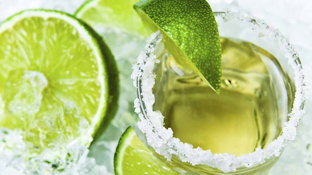 green cocktail with limes