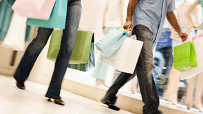 couple walk around shopping centre with bags