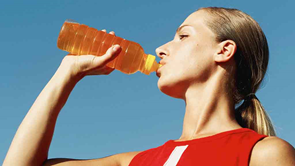 woman drinking orange sports drink