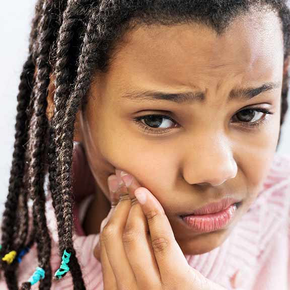 young girl with dental pain sq