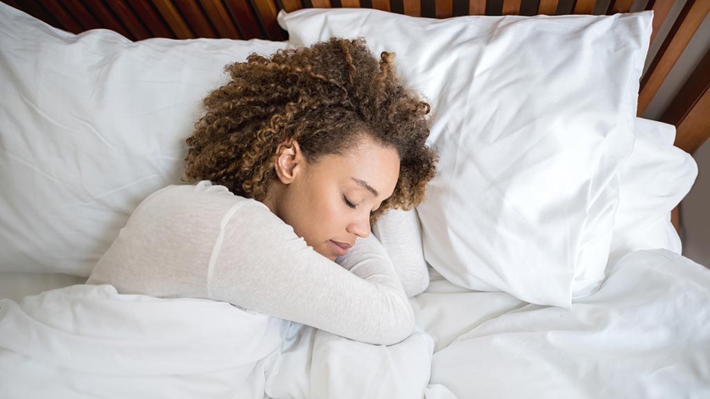 woman sleeping on fresh pillows