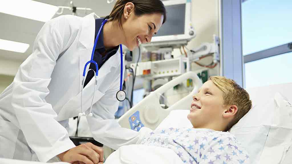 Doctor talking with patient in hospital bed