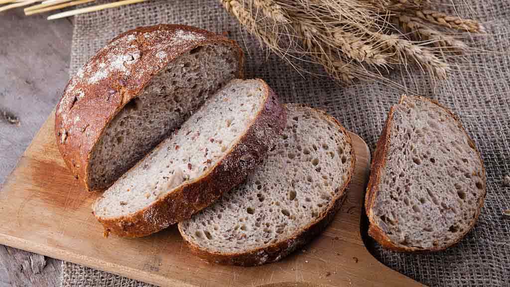 sliced wholemeal bread on wooden board