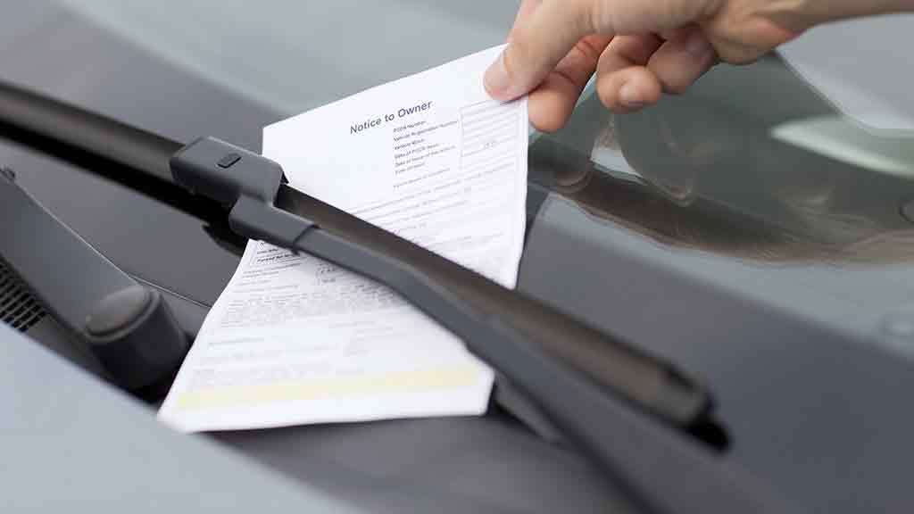 person lifts fine off car