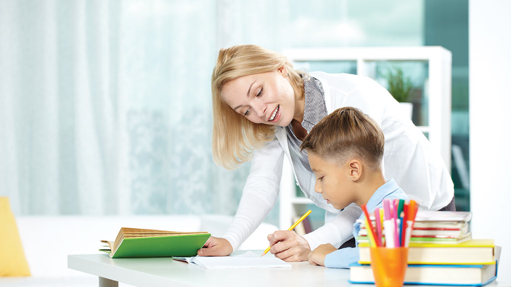 boy studying with teacher