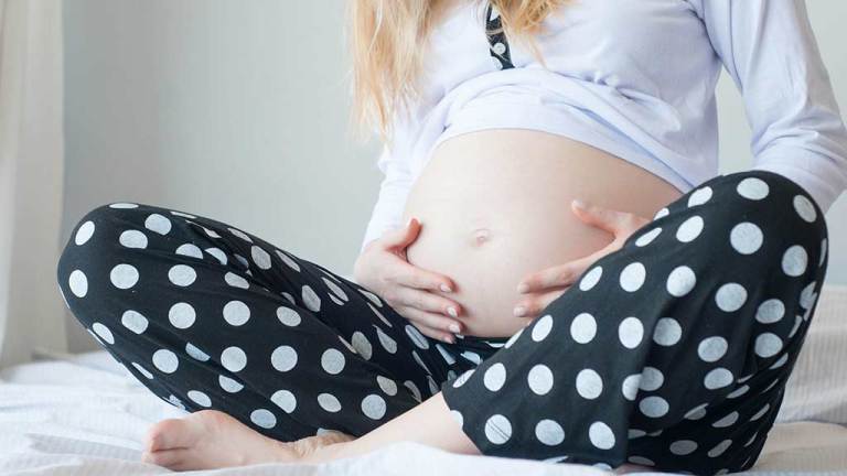pregnant woman holding belly mortgages