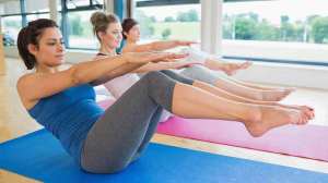 women exercising on gym mats