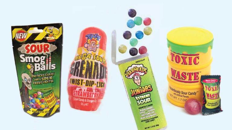 packets of sour lollies on background lead