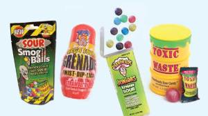 packets of sour lollies on background lead