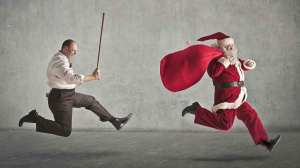 man with stick chasing santa claus