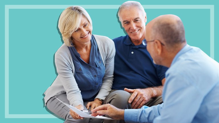 senior couple speaking with financial planner