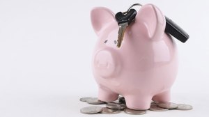 piggy bank with car keys on top