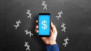 Smartphone surrounded by dollar symbols
