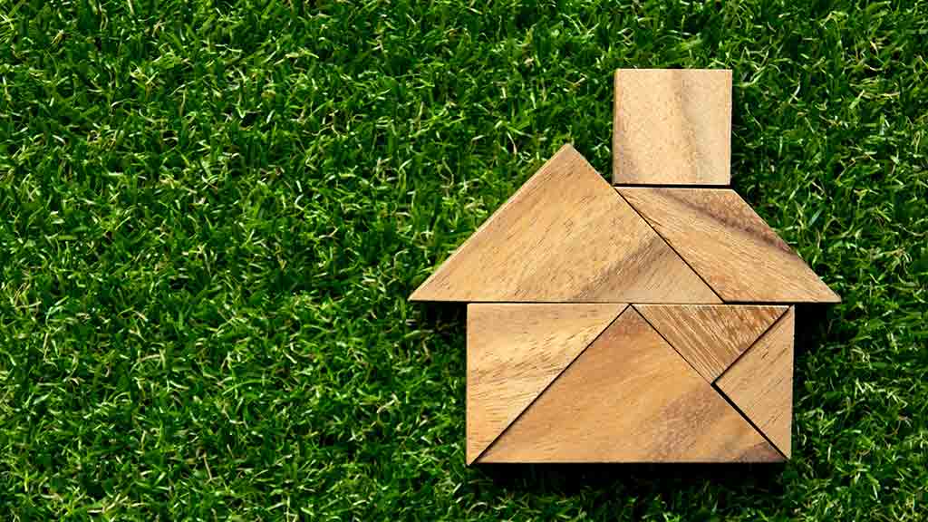 house_made_of_blocks_on_grass_background