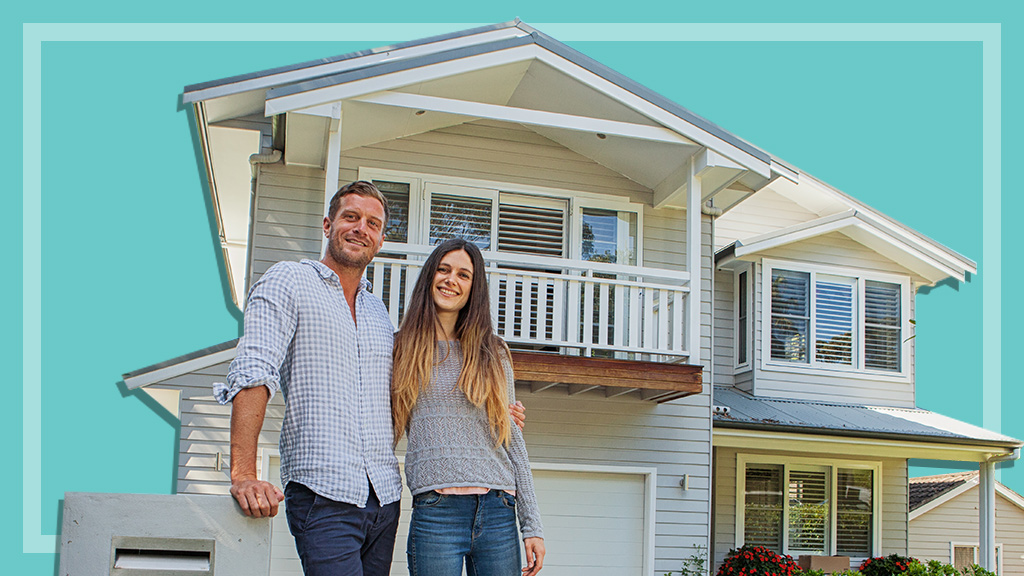 couple in front of new home