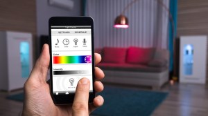 person_using_smart_light_control_with_phone
