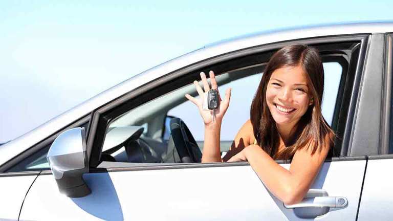 woman waving from a car window