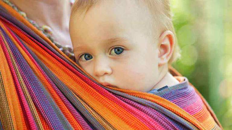 baby in sling carrier