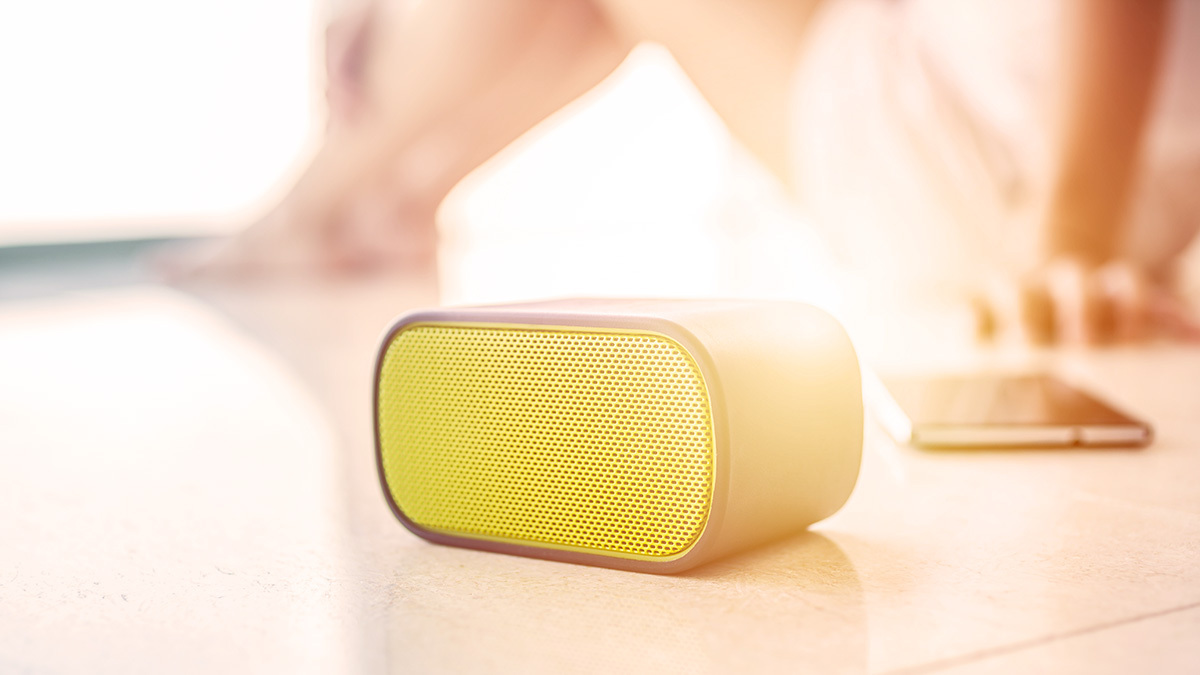 woman with portable bluetooth speaker